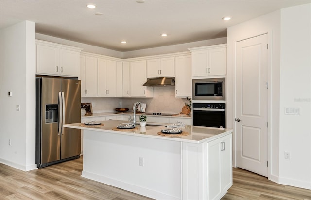 kitchen featuring black appliances, under cabinet range hood, white cabinetry, and backsplash