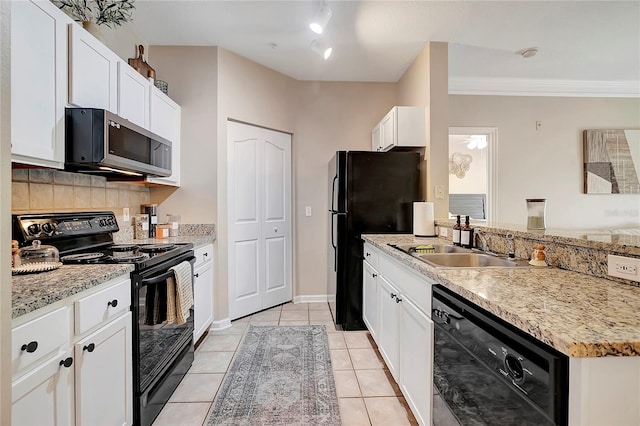 kitchen featuring white cabinets, light tile patterned floors, tasteful backsplash, black appliances, and crown molding