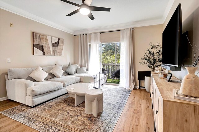 living room featuring light wood-type flooring, ceiling fan, and crown molding