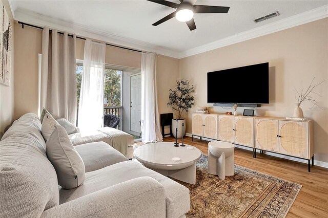 living room with ceiling fan, hardwood / wood-style flooring, and crown molding