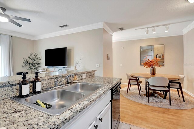 kitchen with dishwasher, white cabinetry, light hardwood / wood-style flooring, ornamental molding, and ceiling fan