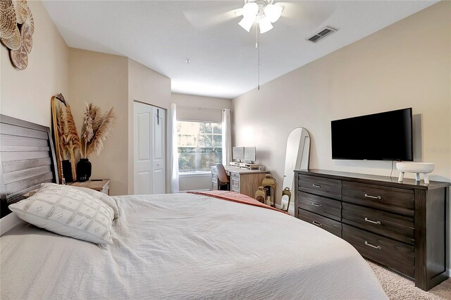 bedroom with light carpet, ceiling fan, and a closet