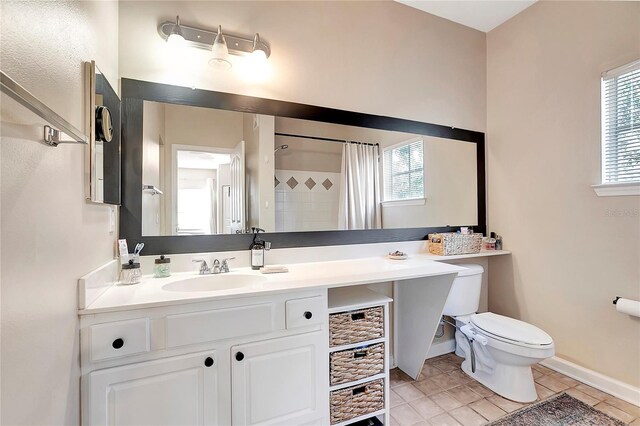 bathroom featuring walk in shower, vanity, tile patterned flooring, and toilet