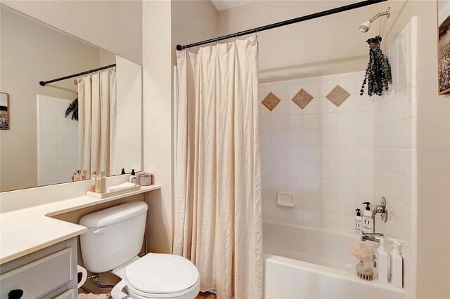 bathroom with shower / tub combo, toilet, and vanity