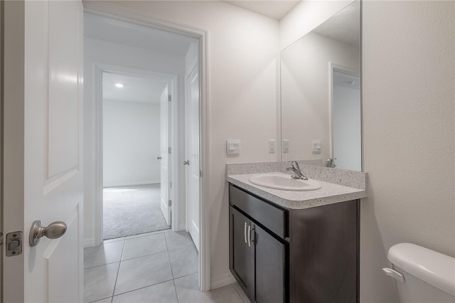 bathroom with tile patterned flooring, vanity, and toilet