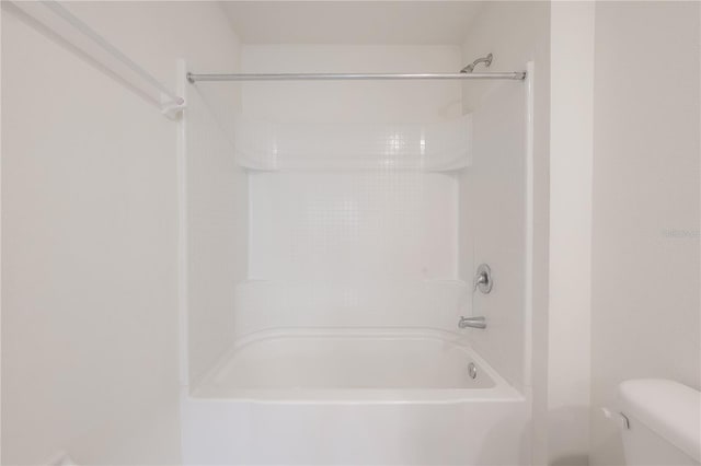 bathroom with toilet and shower / bathing tub combination