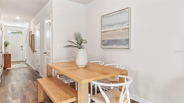 dining space with dark hardwood / wood-style floors