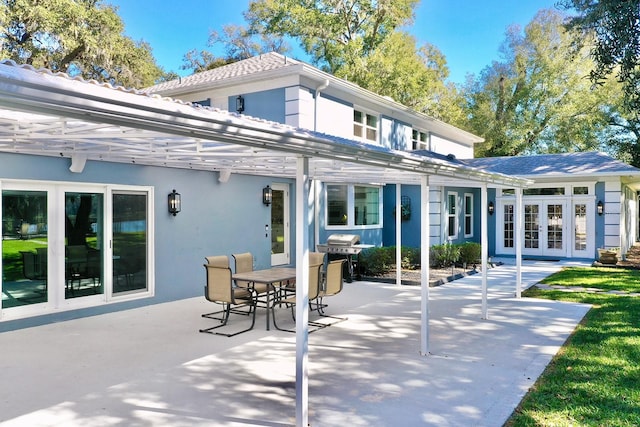 back of property with french doors and a patio area