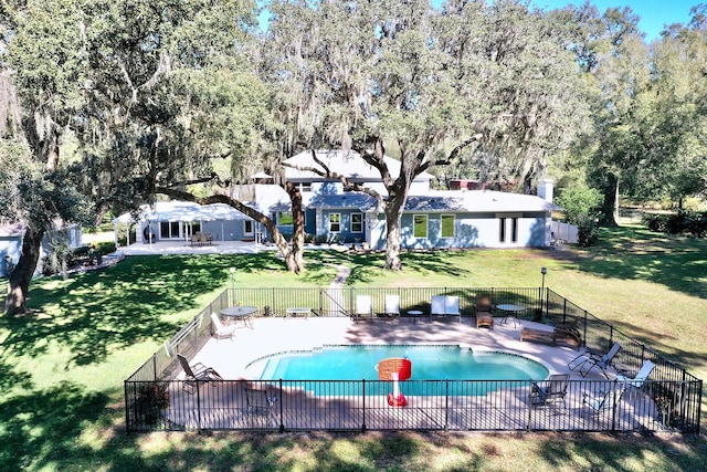 view of pool with a patio and a yard