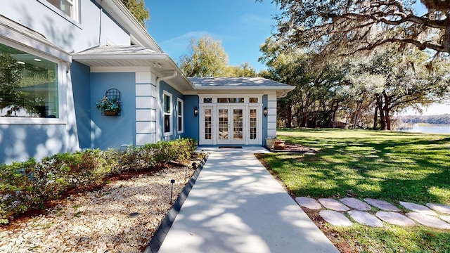 view of exterior entry with a yard