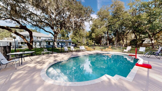 view of swimming pool with a patio