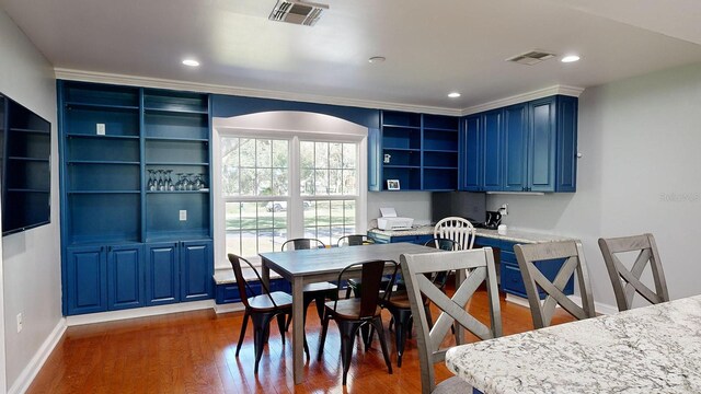 dining room featuring ornamental molding and dark hardwood / wood-style floors