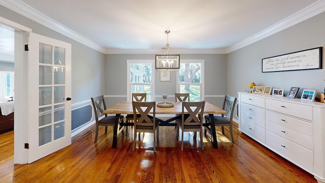 dining room featuring dark wood-type flooring and crown molding