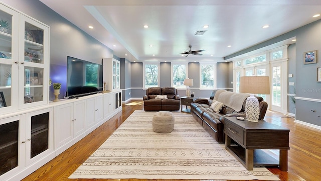 living room featuring ceiling fan and hardwood / wood-style floors