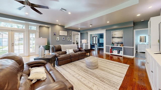 living room with ceiling fan, dark hardwood / wood-style floors, and french doors