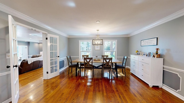 dining room featuring ornamental molding and dark hardwood / wood-style floors