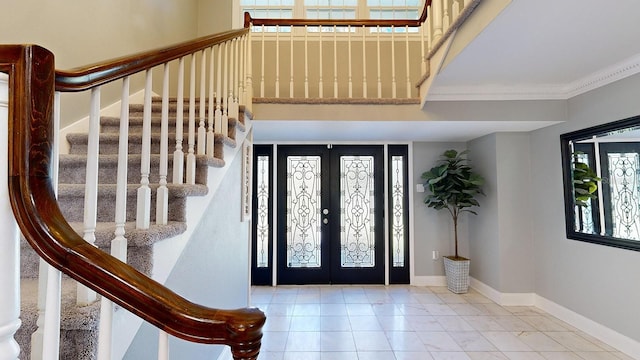 entryway featuring french doors and crown molding