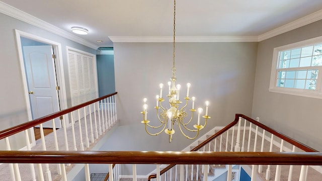 staircase featuring carpet floors, ornamental molding, and a chandelier