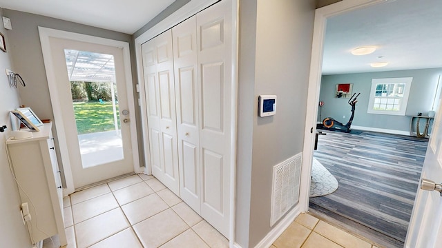 doorway to outside featuring light tile patterned floors