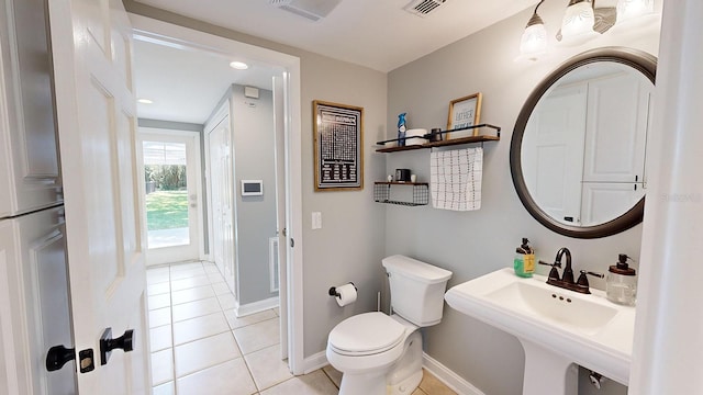 bathroom with toilet and tile patterned floors