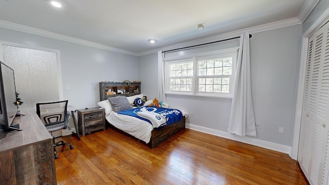 bedroom with hardwood / wood-style flooring and crown molding