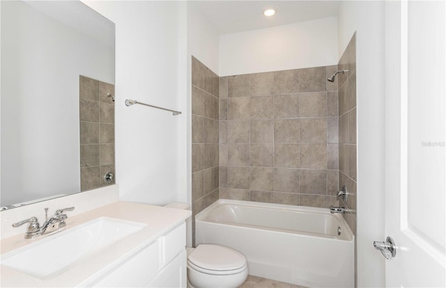 full bathroom featuring vanity, tiled shower / bath combo, and toilet