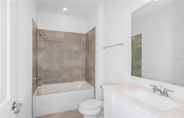 full bathroom featuring tile patterned flooring, vanity, tiled shower / bath combo, and toilet