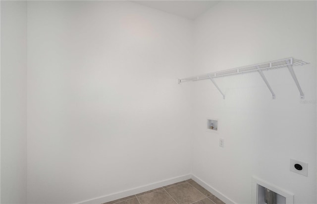 washroom featuring electric dryer hookup, washer hookup, and light tile patterned floors