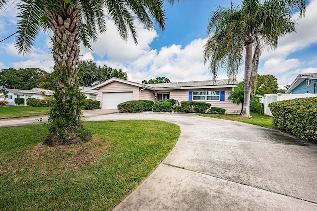 single story home featuring a garage and a front yard