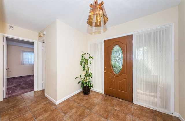 foyer entrance with tile patterned flooring and baseboards