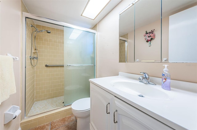 bathroom featuring vanity, tile patterned flooring, a shower stall, and toilet