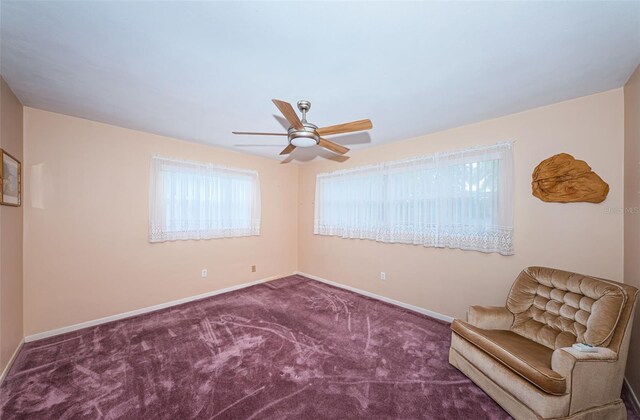 unfurnished room with carpet floors, a ceiling fan, and baseboards