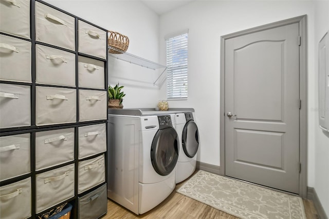 281 Villa Corte Dr, Lutz, FL 33549 - laundry room featuring washing machine and dryer, light wood-style floors, and baseboards