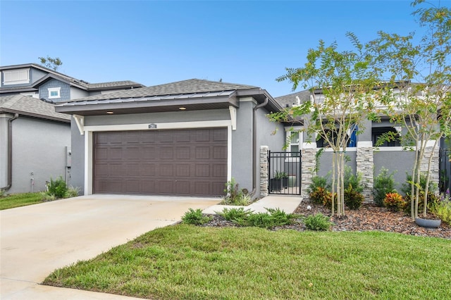 view of front of property with a front lawn and a garage