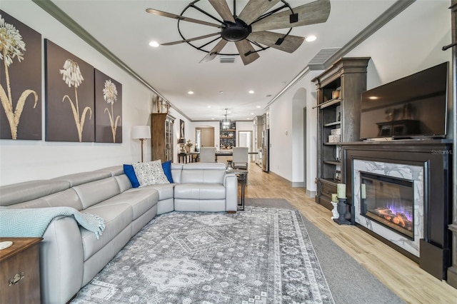 281 Villa Corte Dr, Lutz, FL 33549 - living area featuring crown molding, light wood-style floors, a fireplace, recessed lighting, and ceiling fan