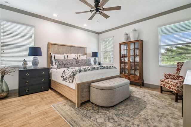 bedroom with ornamental molding, light hardwood / wood-style flooring, and ceiling fan