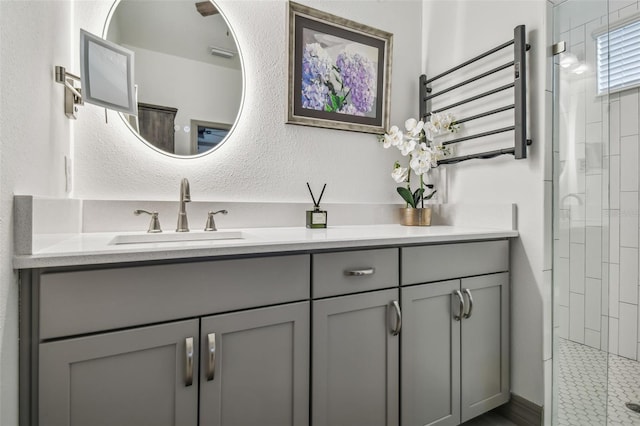 281 Villa Corte Dr, Lutz, FL 33549 - bathroom featuring a stall shower, vanity, a towel warming rack, and a textured wall