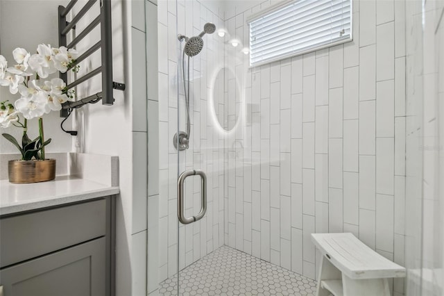 bathroom featuring vanity, tile patterned floors, and a shower with door