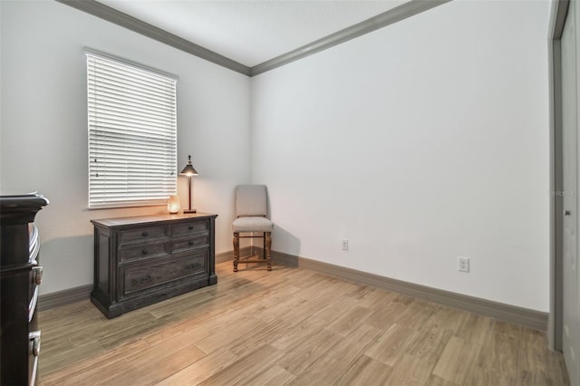 sitting room featuring ornamental molding and light hardwood / wood-style flooring