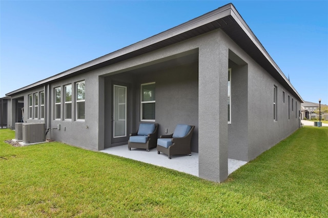 281 Villa Corte Dr, Lutz, FL 33549 - rear view of property with stucco siding, a patio, central AC unit, and a yard