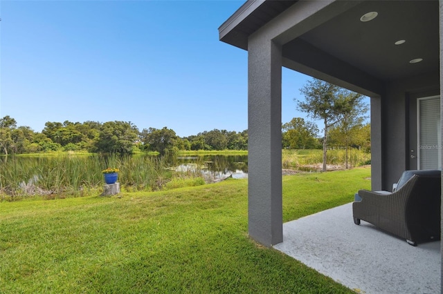 view of yard with a patio and a water view