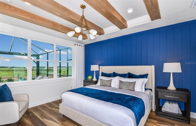 bedroom with dark hardwood / wood-style flooring, beamed ceiling, and a notable chandelier