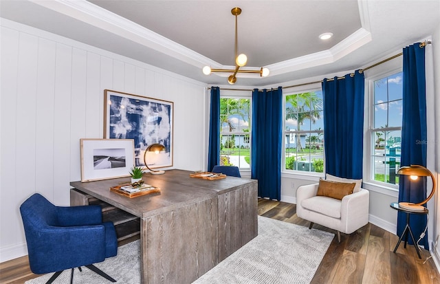 home office featuring an inviting chandelier, a raised ceiling, crown molding, and dark hardwood / wood-style flooring