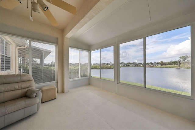 unfurnished sunroom with a water view, vaulted ceiling, and ceiling fan