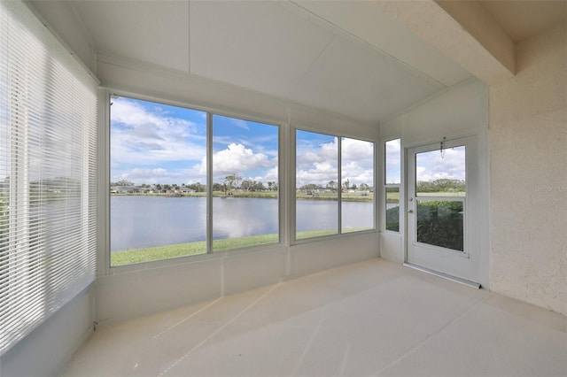 unfurnished sunroom with a water view, lofted ceiling, and plenty of natural light