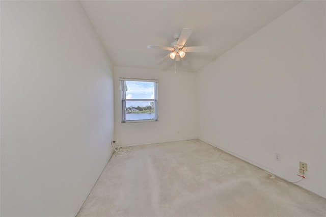 unfurnished room featuring light colored carpet and ceiling fan