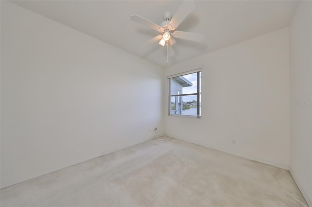 spare room with light carpet and ceiling fan