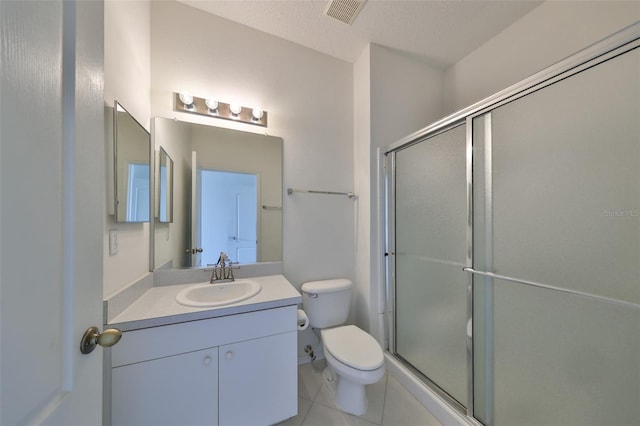 bathroom featuring walk in shower, vanity, toilet, and tile patterned floors