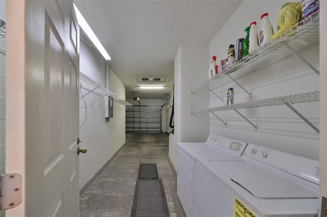 washroom featuring a textured ceiling and separate washer and dryer