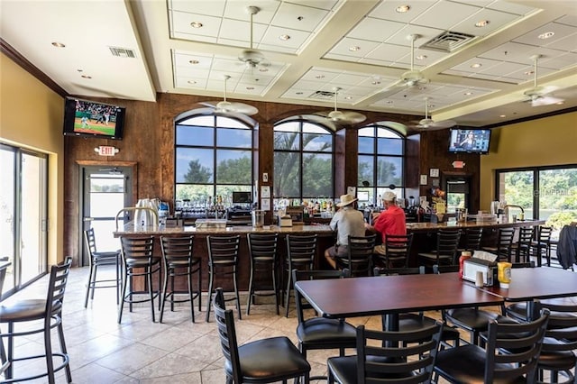 dining area with a high ceiling, beamed ceiling, light tile patterned flooring, ceiling fan, and coffered ceiling